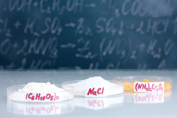 Various chemicals on the background of the blackboard — Stock Photo, Image
