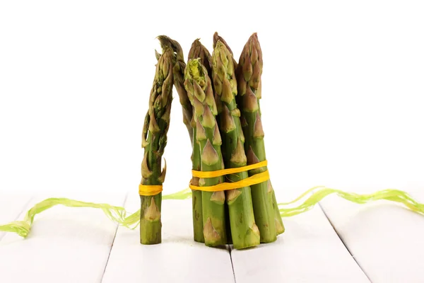 Useful asparagus on wooden table on white background — Stock Photo, Image