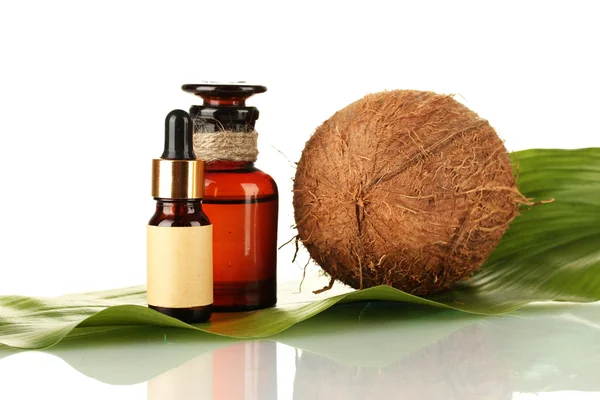 Olej kokosowy w butelkach z kokosy na białym tle — Zdjęcie stockowe