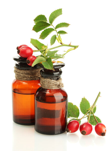 medicine bottles with hip roses, isolated on white