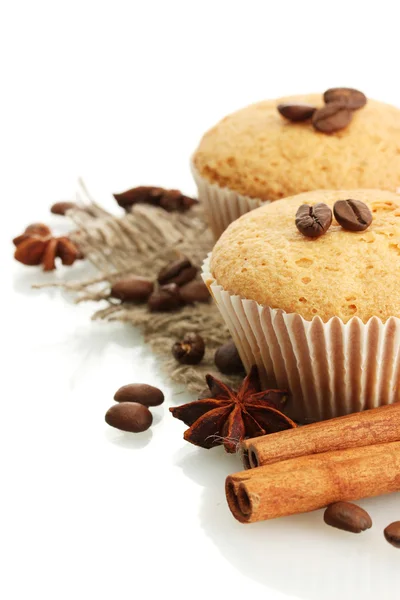 Tasty muffin cakes on burlap, spices and coffee seeds, isolated on white — Zdjęcie stockowe