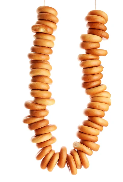Välsmakande bagels på rep, isolerade på vitt — Stockfoto