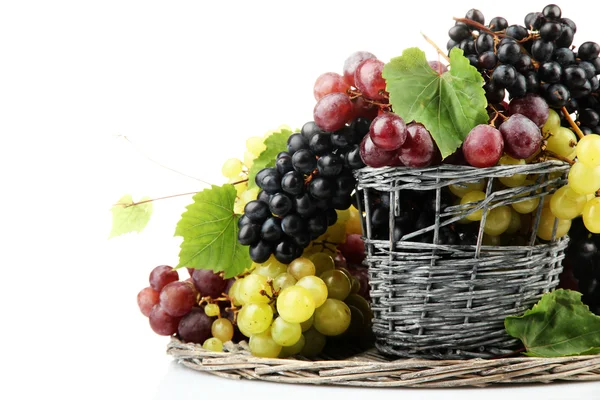 Assortment of ripe sweet grapes in basket, isolated on white — Stock Photo, Image