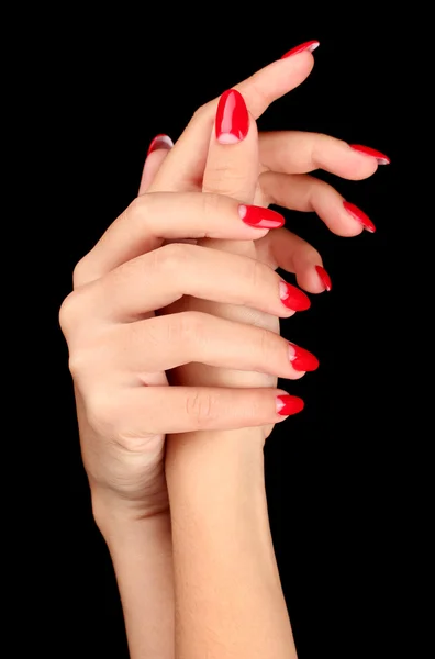 Beautiful female hands with red nails isolated on black — Stock Photo, Image