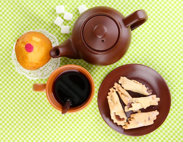 Widok z góry o filiżankę herbaty i czajnik na zielone obrusy — Zdjęcie stockowe