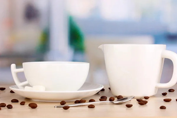 A cup of strong coffee and sweet cream on wooden table on room background — Stock Photo, Image