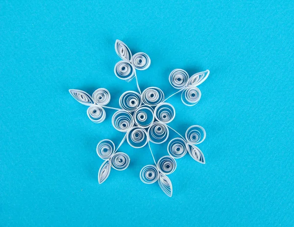 Beautiful paper snowflake, on blue background — Stock Photo, Image