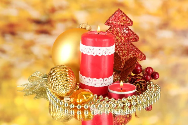 Red candle with christmas decoration on bright background — Stock Photo, Image