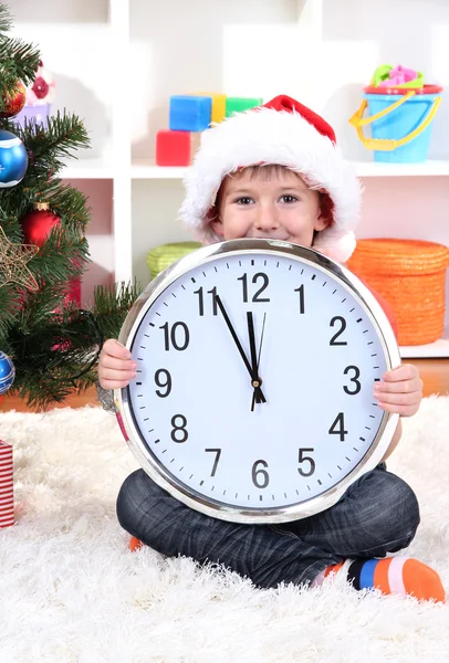 Little boy with clock in anticipation of New Year Royalty Free Stock Images