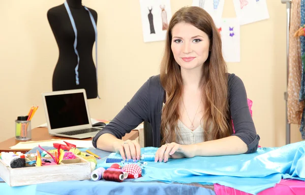 Beautiful young dressmaker in workroom — Stock Photo, Image