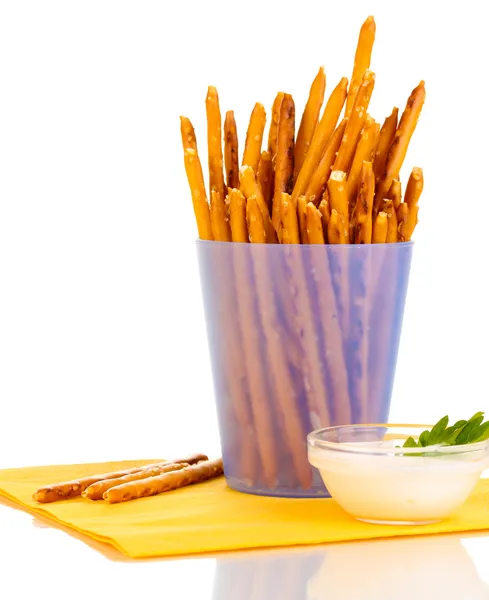 Tasty crispy sticks in purple plastic cup isolated on white — Stock Photo, Image