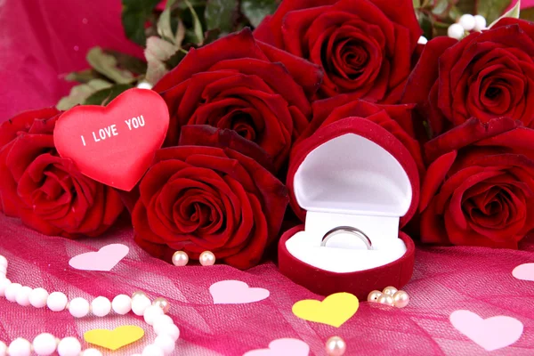 Beautiful bouquet of roses on pink fabric close-up — Stock Photo, Image