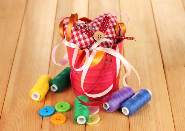Cubo de color con cintas multicolor e hilo sobre fondo de madera — Foto de Stock