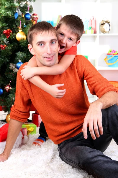 Father and son near Christmas tree — Stock Photo, Image