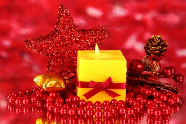 Red candle with christmas decoration on bright background — Stock Photo, Image