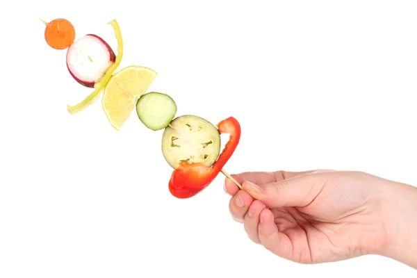 Sliced vegetables on wooden pick holding in hand isolated on white — Stock Photo, Image