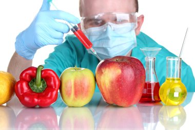 Scientist injecting GMO into the vegetables clipart