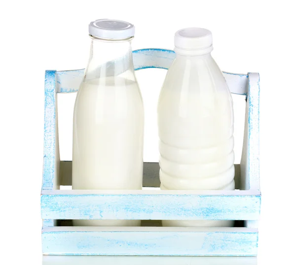 Milk in bottles in wooden box isolated on white — Stock Photo, Image