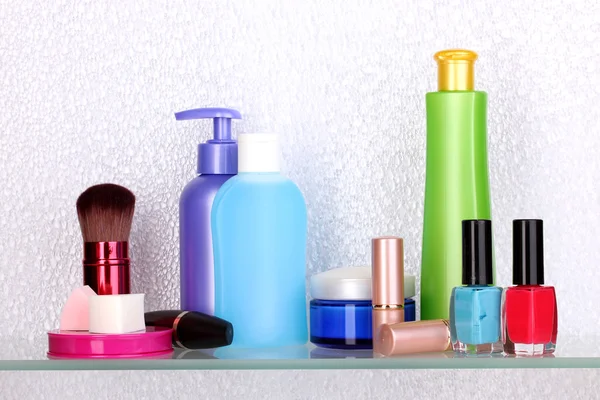 Shelf with cosmetics and toiletries in bathroom — Stock Photo, Image