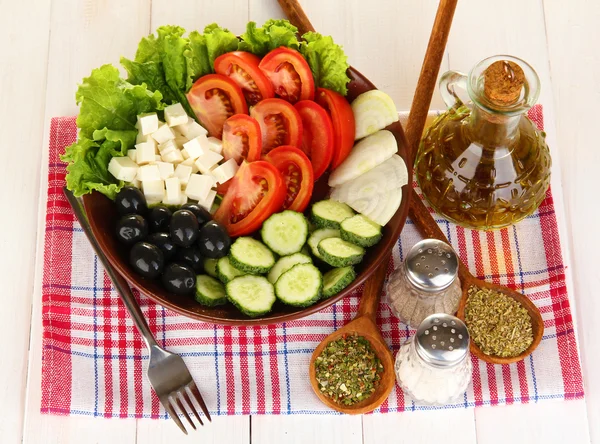 Смачний грецький салат зі спеціями на білому тлі дерев'яні Закри — стокове фото