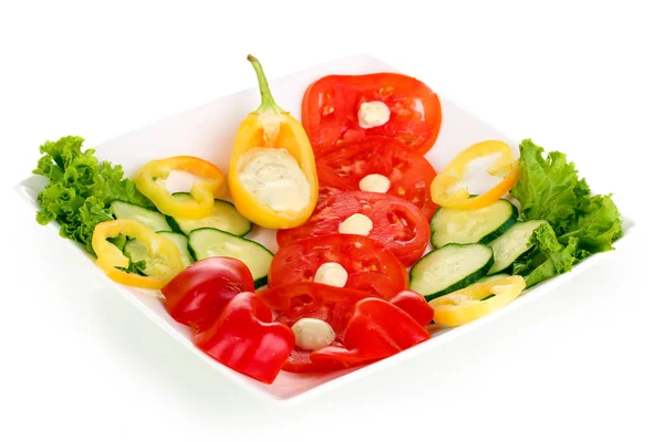 Chopped vegetables and sauce on plate isolated on white — Stok fotoğraf