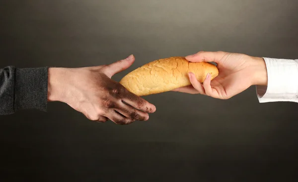 Helping the homeless, on black background close-up — Stock Photo, Image