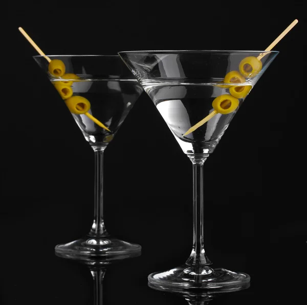 Martini glasses and olives isolated on black — Stock Photo, Image