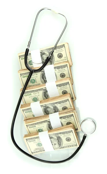 Healthcare cost concept: stethoscope and dollars isolated on white — Stock Photo, Image