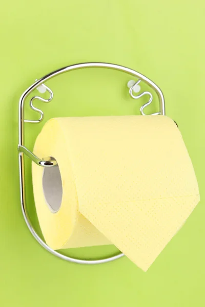 Roll of toilet paper on holder fixed to wall — Stock Photo, Image