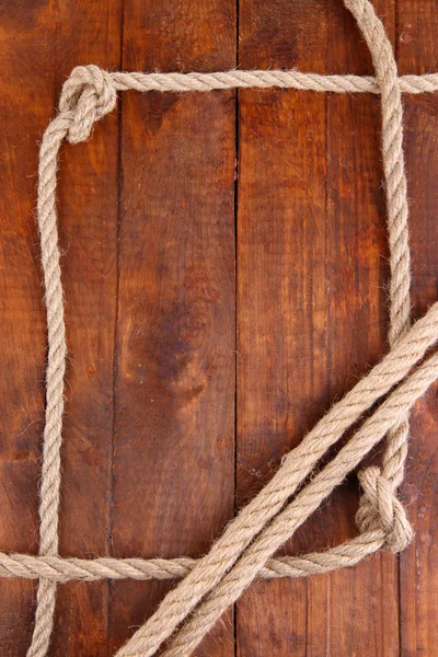 Frame composed of rope on wooden background Royalty Free Stock Images