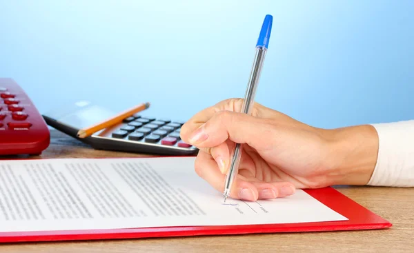 Signing of a treaty, on blue background close-up — Stock Photo, Image