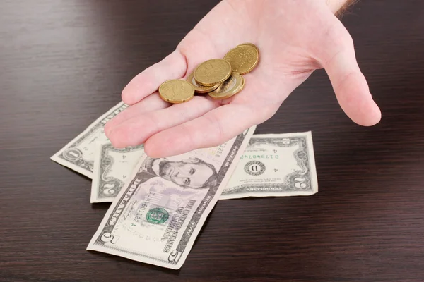 Counting money in hand on wooden table background — Stock Photo, Image