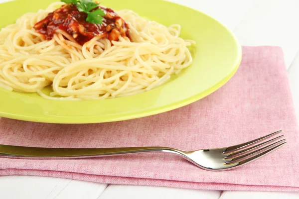 Italian spaghetti in plate on wooden table — Stock Photo, Image