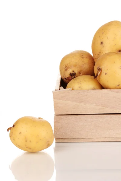 Ripe potatoes on wooden box isolated on white — Stock Photo, Image