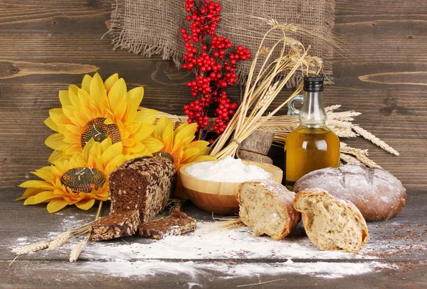 Rye bread on wooden table on wooden background — Stock Photo, Image