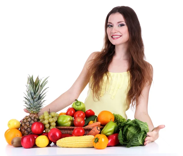 Mulher bonita com legumes e frutas na mesa isolada em branco — Fotografia de Stock