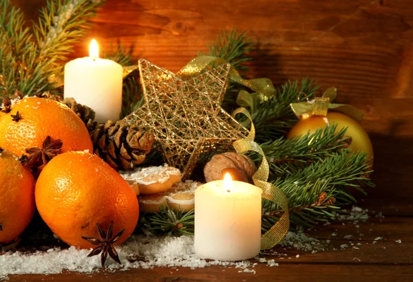 Christmas composition with oranges and fir tree, on wooden background — Stock Photo, Image