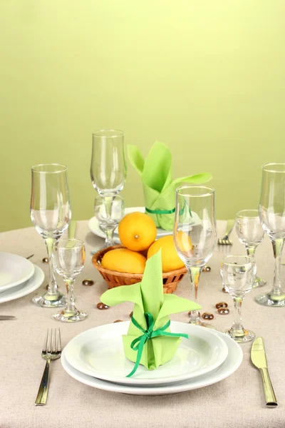 Table setting in green and yellow tones on color background — Stock Photo, Image