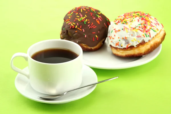 Tasty donuts on color plate on color background — Stock Photo, Image