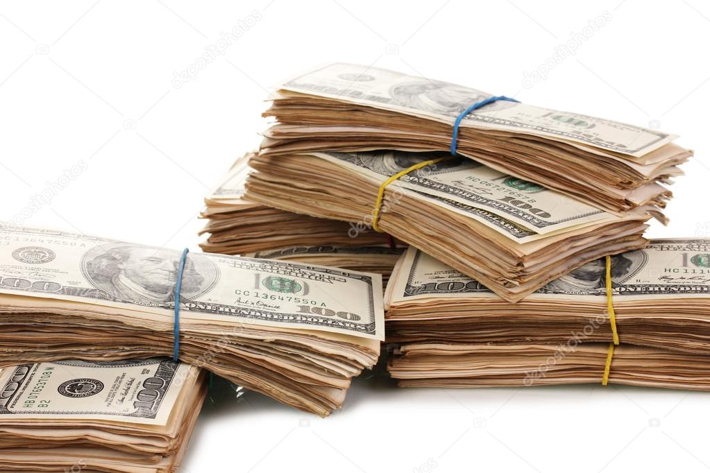 Stacks of one hundred dollars banknotes close-up isolated on white