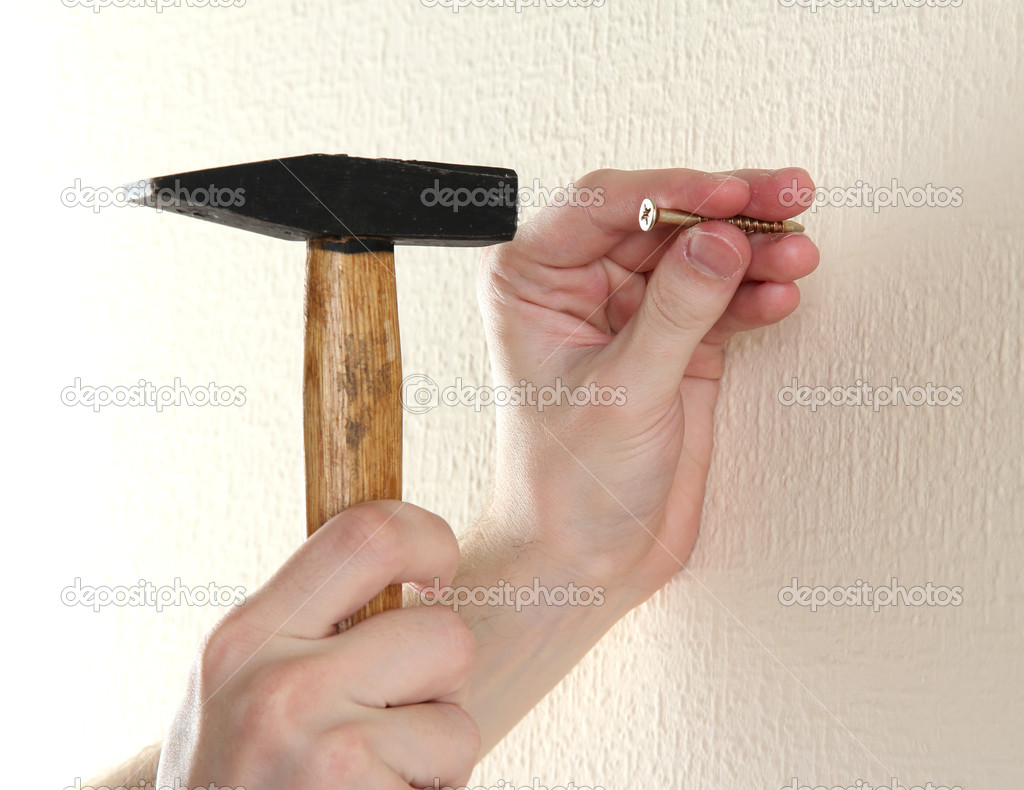 man hands with nail and hammer