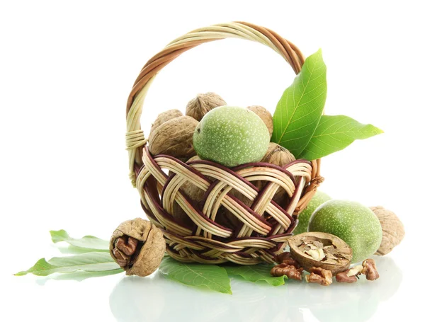 Walnuts with green leaves in basket, isolated on white — Stock Photo, Image