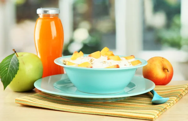 Tasty dieting food and bottle of juice, on wooden table — Stock Photo, Image