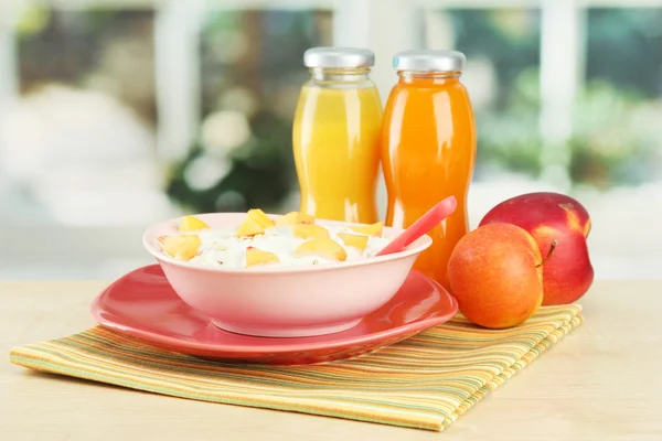 Tasty dieting food and bottles of juice, on wooden table — Stock Photo, Image