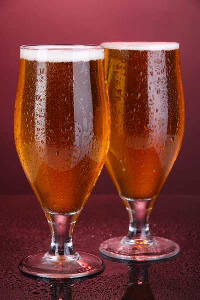 Glasses of beer on pink background — Stock Photo, Image