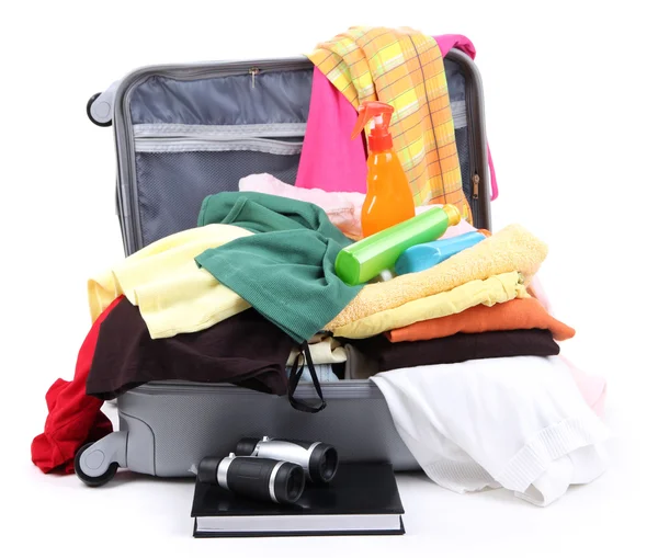 Open silver suitcase with clothing isolated on white — Stock Photo, Image