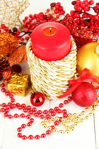 Red candle with christmas decoration on light background — Stock Photo, Image