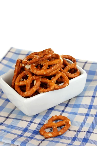 Tasty pretzels in white bowl isolated on white — Stock Photo, Image