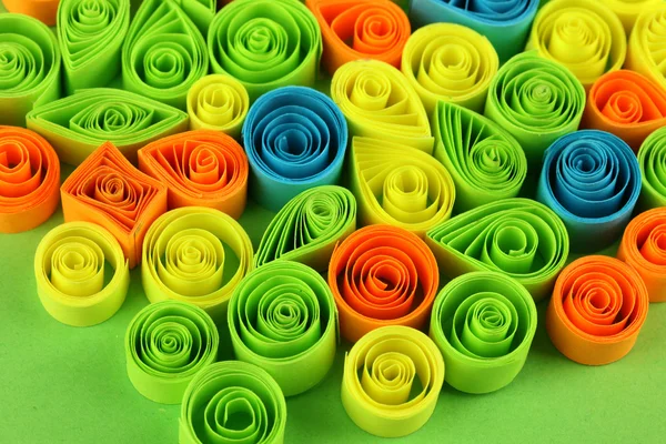 Colorful quilling on green background close-up — Stock Photo, Image