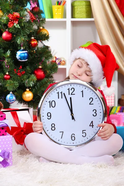 Beautiful little girl sleep in anticipation of New Year in festively decorated room Royalty Free Stock Photos